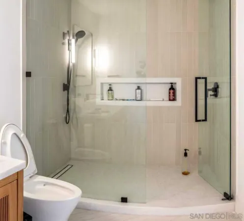 a bathroom with a shower a toilet and sink