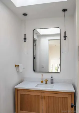 a bathroom with a sink a vanity and a mirror