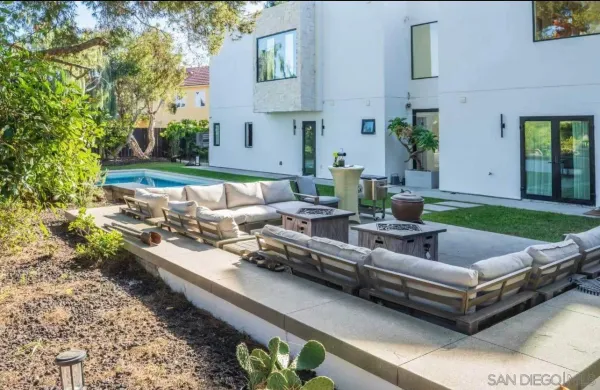 a view of a patio with couches and a table and chairs with potted plants