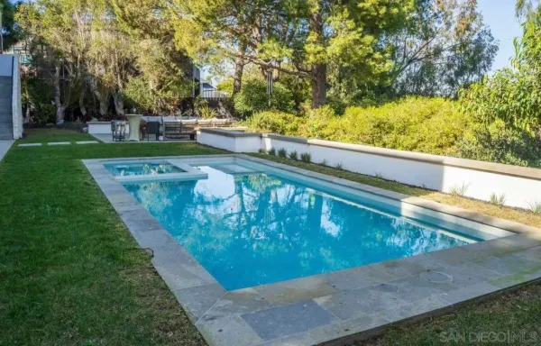 a view of a swimming pool with a yard