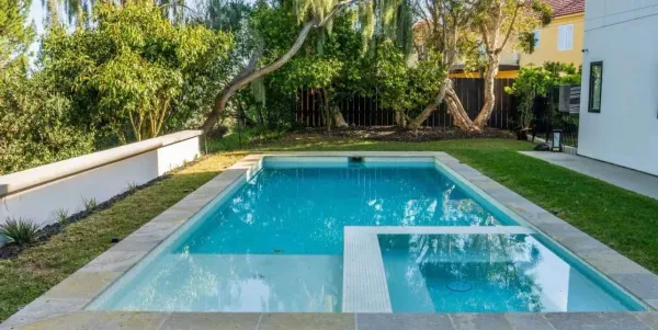 a view of swimming pool with a chair and slides