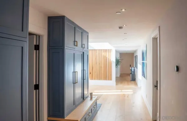 a view of a hallway with wooden shelves