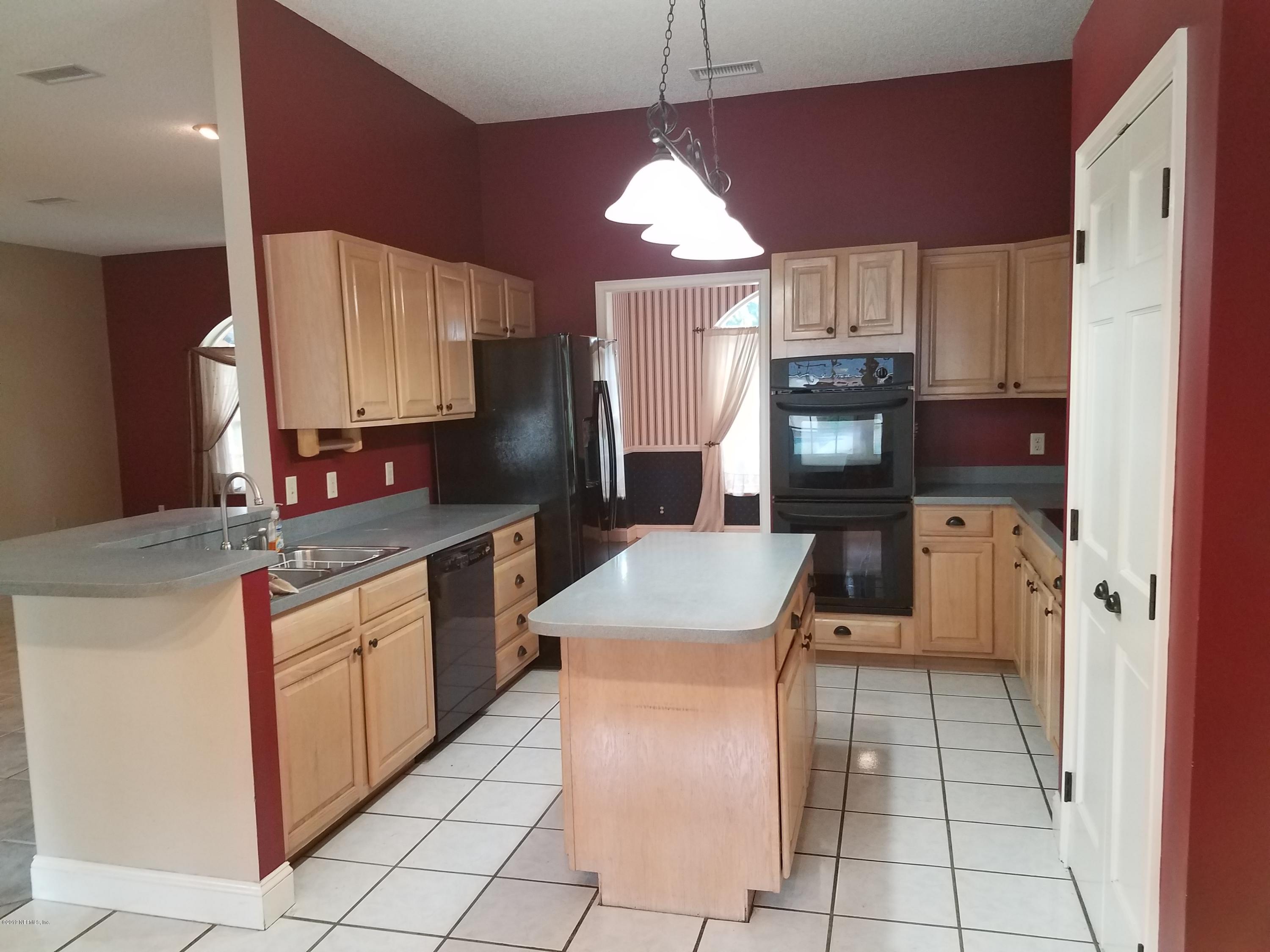 2970 Cortez Road Jacksonville, FL 32246 - Photo 8 of 12 a kitchen with kitchen island granite countertop a sink counter top space appliances and cabinets
