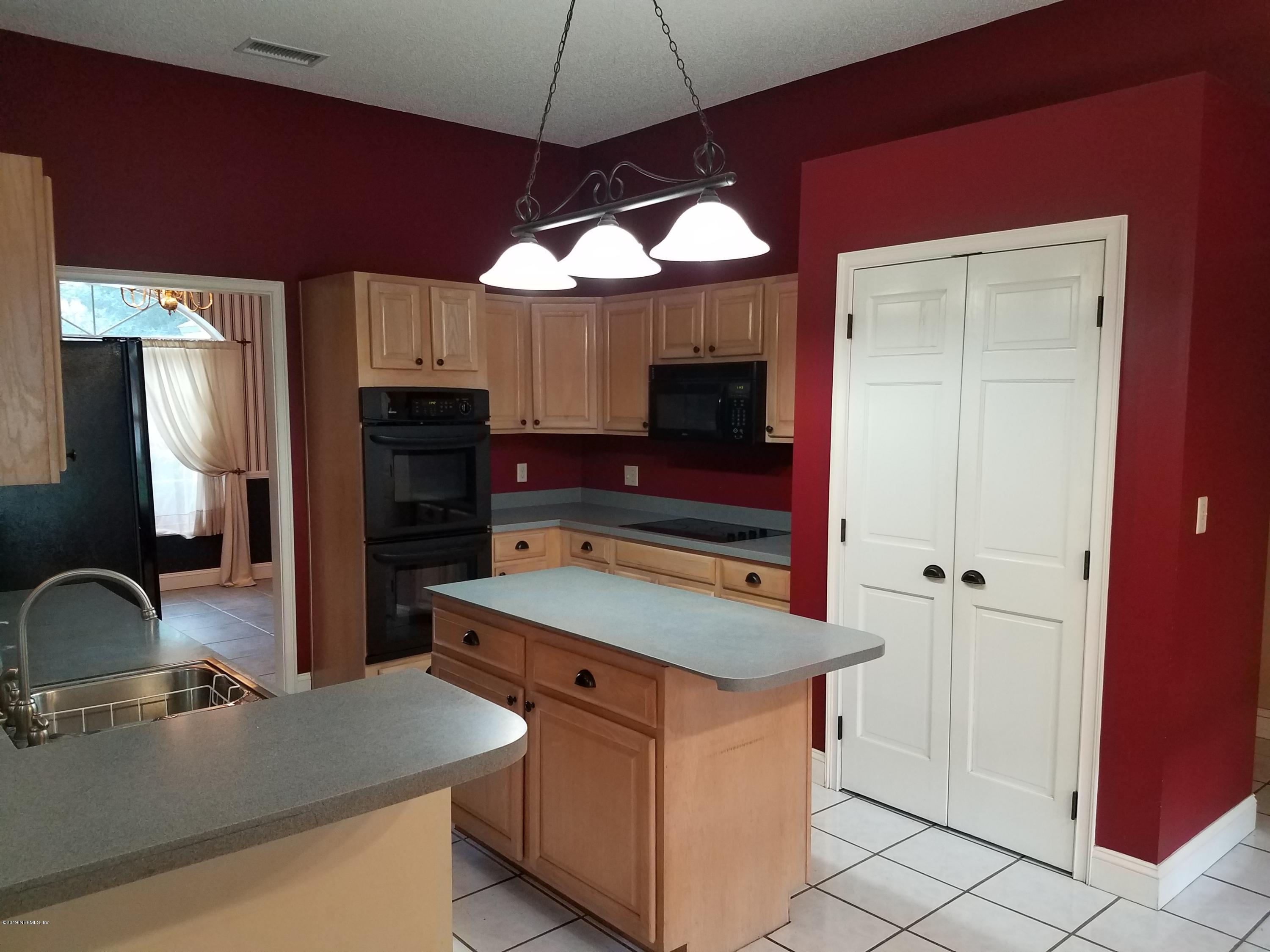 2970 Cortez Road Jacksonville, FL 32246 - Photo 9 of 12 a kitchen with stainless steel appliances a sink stove and refrigerator