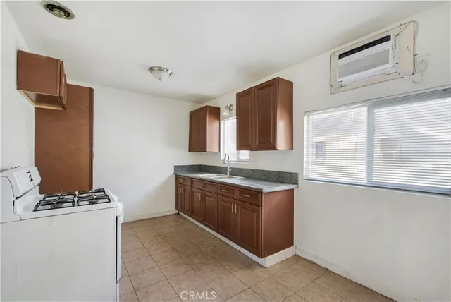 a kitchen with stainless steel appliances granite countertop a stove and a refrigerator