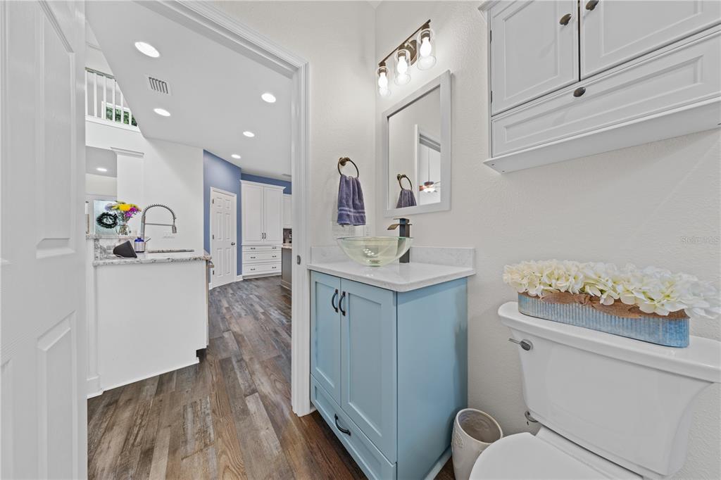 16948 Deer Island Road Tavares, FL 32778 - Photo 27 of 67 a bathroom with a sink toilet vanity and mirror