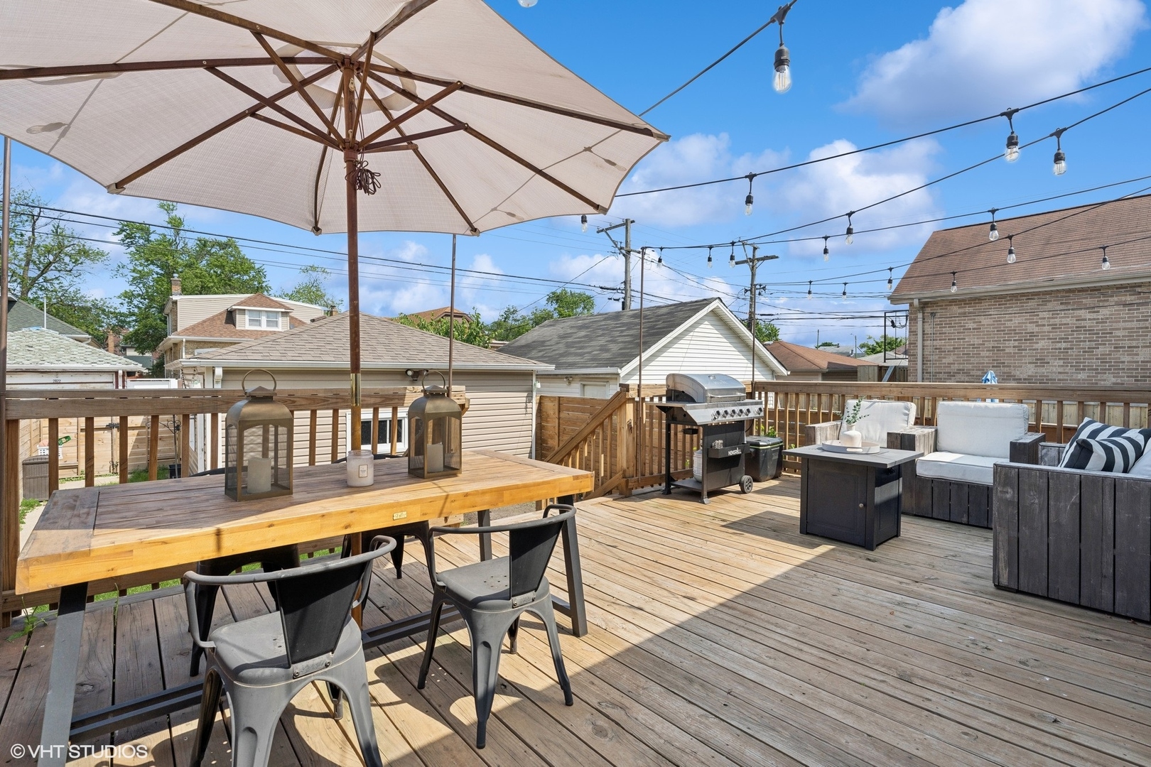 2819 North Rutherford Avenue Chicago, IL 60634 - Photo 24 of 28 a view of a roof deck with table and chairs under an umbrella with wooden floor