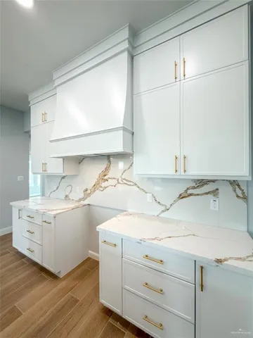 a kitchen with kitchen island a sink stainless steel appliances and a chandelier