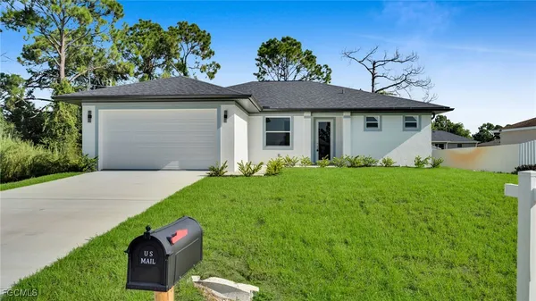 a front view of house with yard and green space