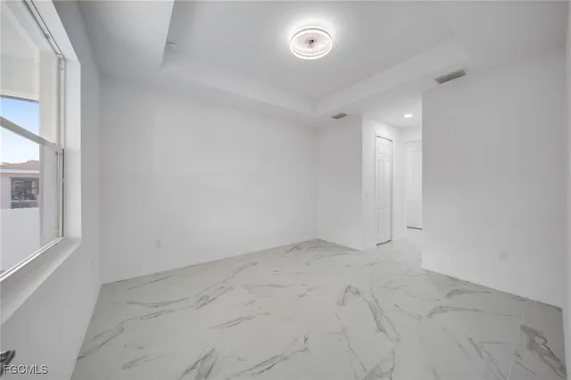 an empty room with a empty space and windows