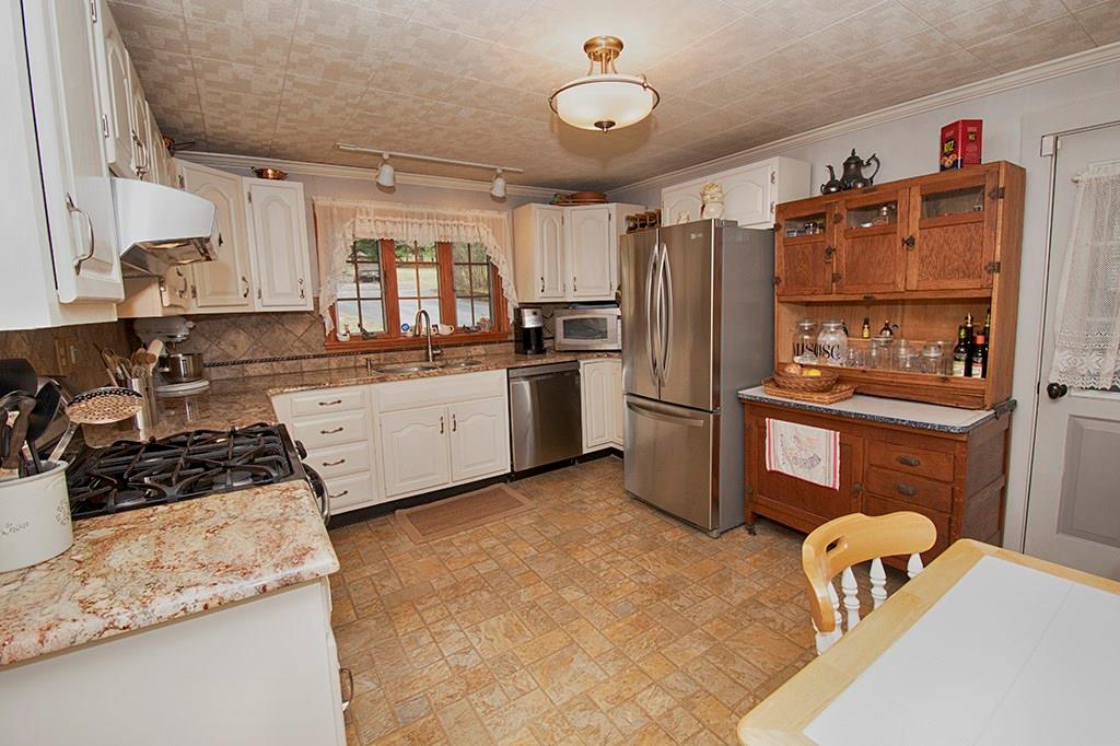 224 Kilgallen Road Butler, PA 16002 - Photo 3 of 25 a kitchen with granite countertop a refrigerator stove and sink