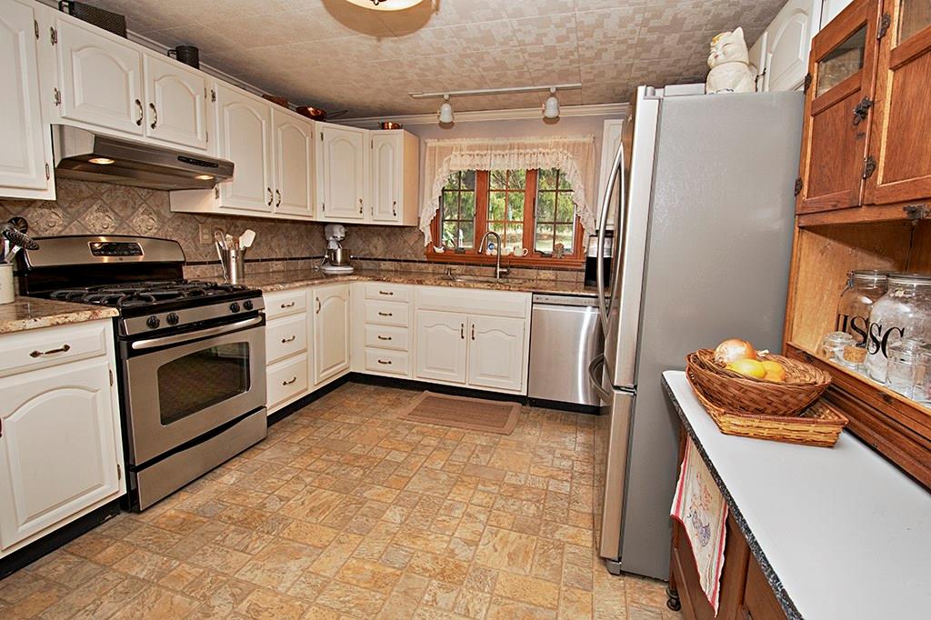 224 Kilgallen Road Butler, PA 16002 - Photo 4 of 25 a kitchen with stainless steel appliances granite countertop a stove a sink and a refrigerator