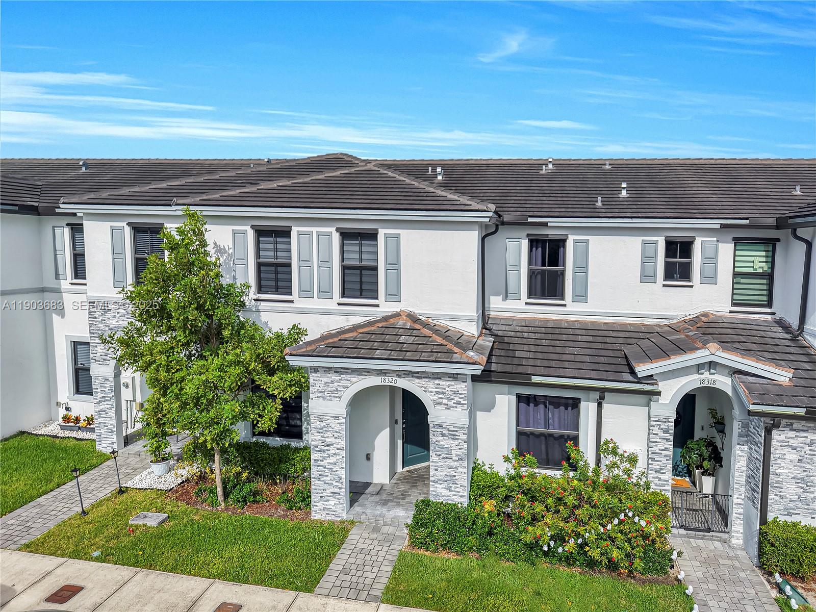 a front view of a house with yard and porch