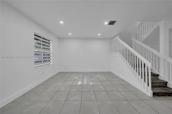 a view of an empty room with stairs