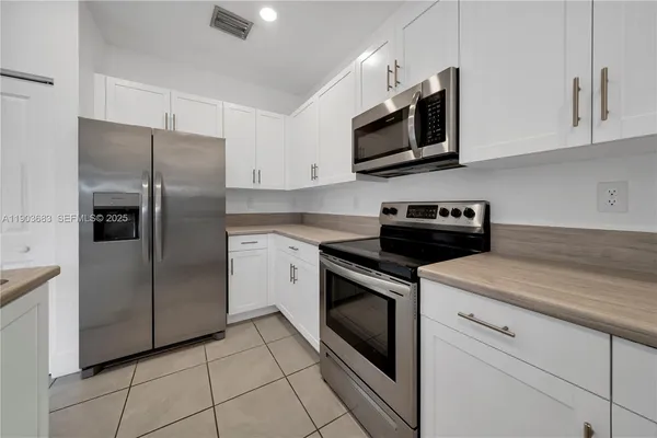 a kitchen with a stove microwave and refrigerator