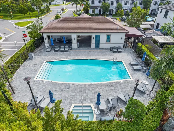 an aerial view of a house with table and chairs