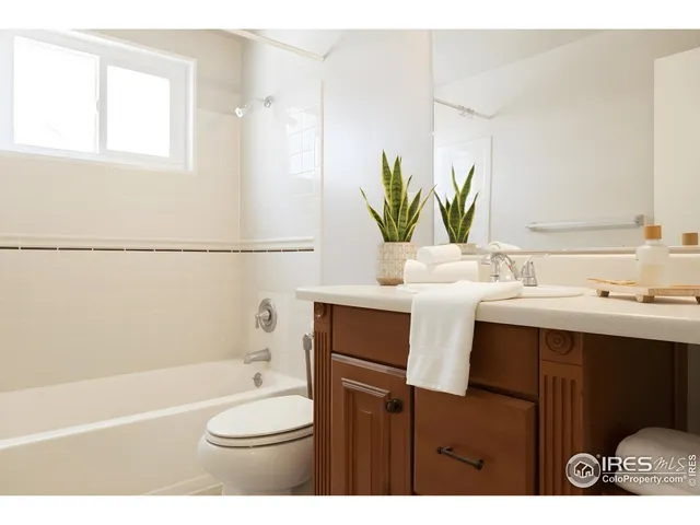 a bathroom with a sink toilet a mirror and shower