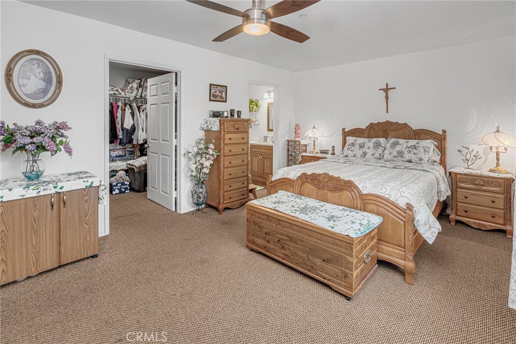 9212 Beverly Road Pico Rivera, CA 90660 - Photo 14 of 43 a spacious bedroom with a bed and ceiling fan