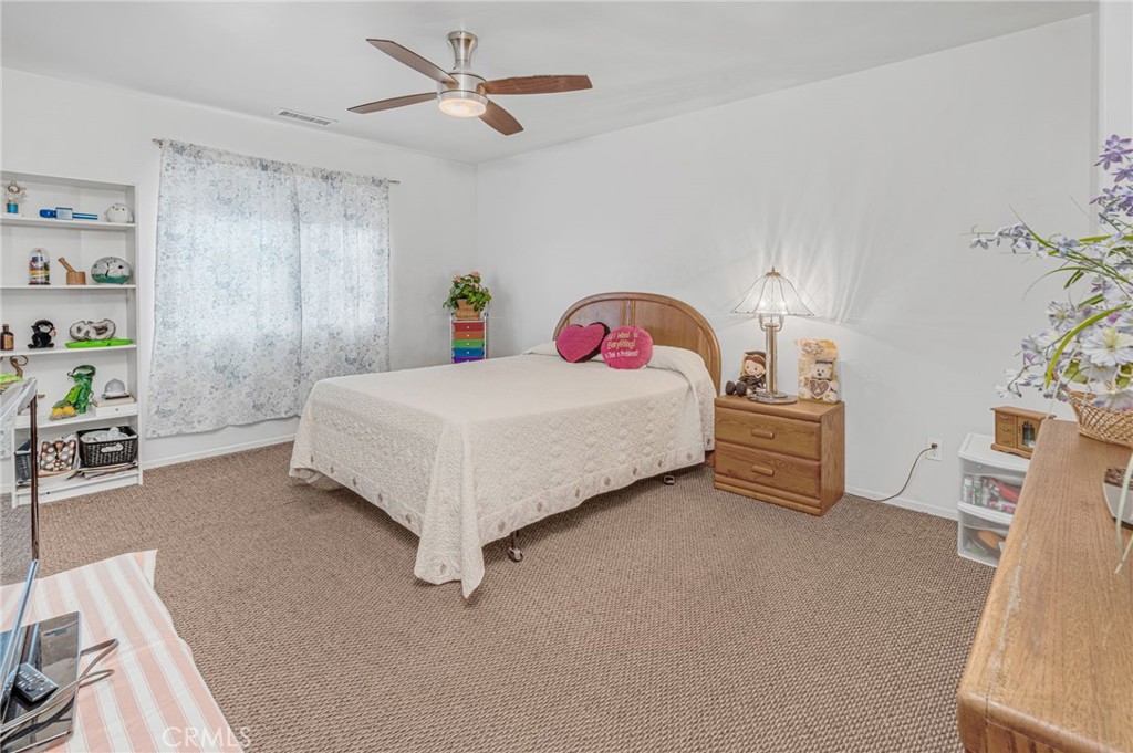9212 Beverly Road Pico Rivera, CA 90660 - Photo 24 of 43 a bedroom with a bed and a chandelier