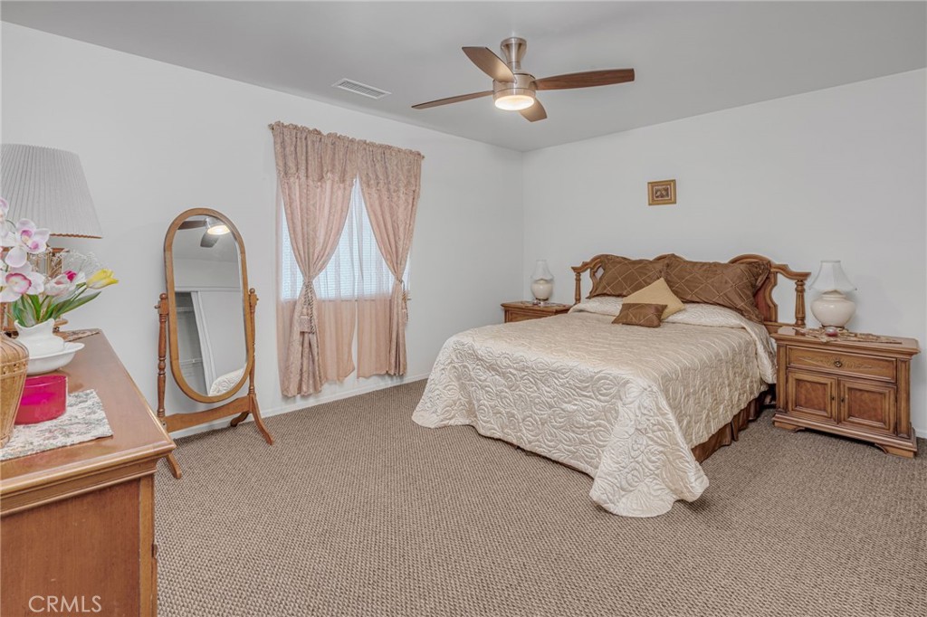 9212 Beverly Road Pico Rivera, CA 90660 - Photo 26 of 43 a bedroom with a bed a dresser and book shelf