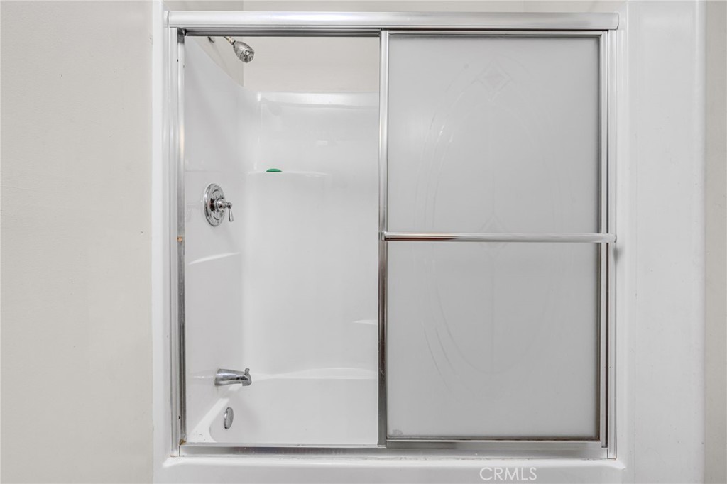 9212 Beverly Road Pico Rivera, CA 90660 - Photo 30 of 43 a bathroom with a glass shower door