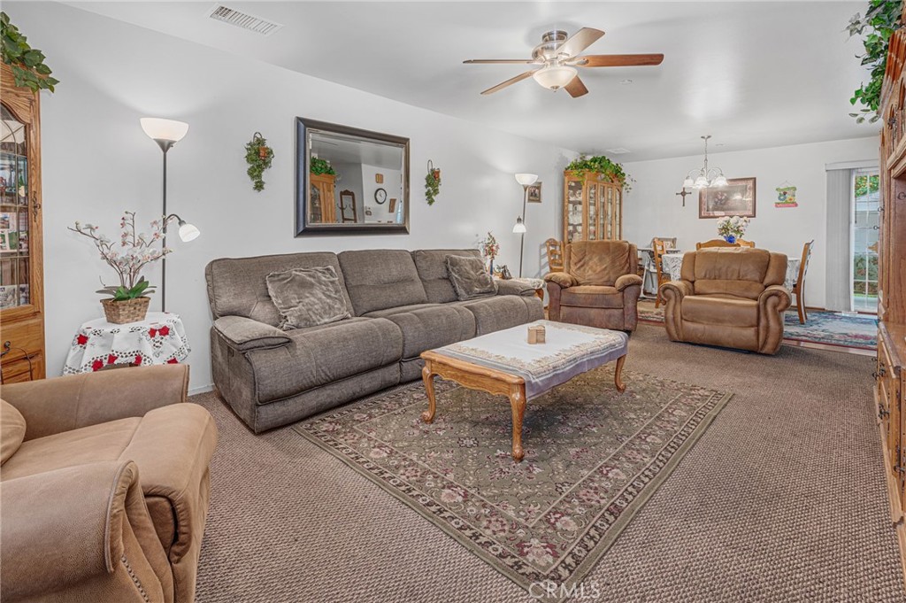 9212 Beverly Road Pico Rivera, CA 90660 - Photo 36 of 43 a living room with furniture a rug and a chandelier