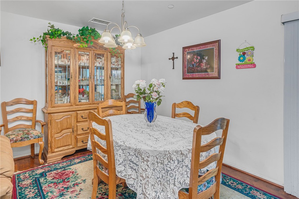 9212 Beverly Road Pico Rivera, CA 90660 - Photo 39 of 43 a view of a dining room with furniture wooden floor and a chandelier