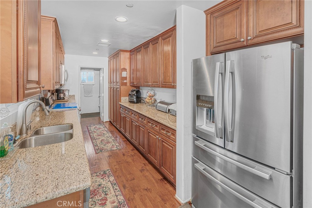 9212 Beverly Road Pico Rivera, CA 90660 - Photo 6 of 43 a kitchen with refrigerator and cabinets