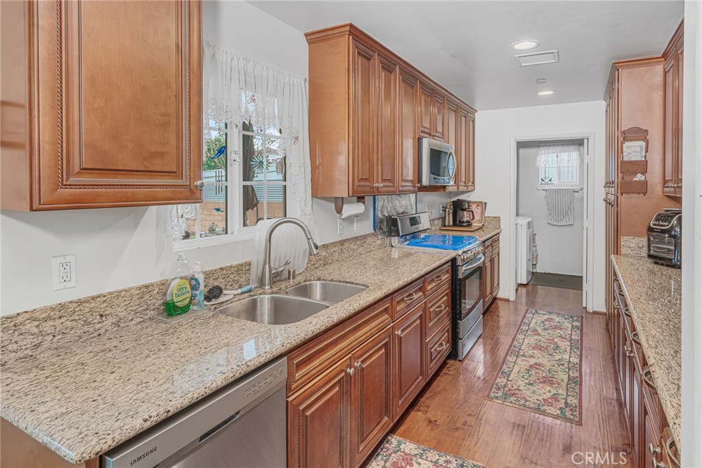 9212 Beverly Road Pico Rivera, CA 90660 - Photo 7 of 43 a kitchen with stainless steel appliances granite countertop a sink stove and cabinets