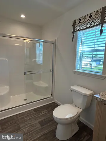 a bathroom with a toilet and a shower