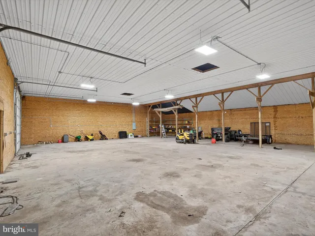 a kitchen with stainless steel appliances granite countertop a stove refrigerator and a dining table