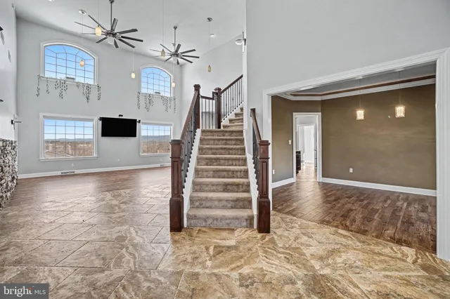 a bathroom with a granite countertop sink a toilet and shower