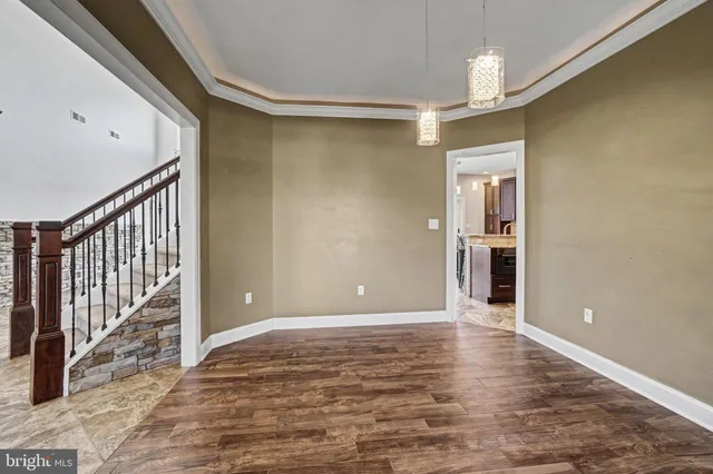 an empty room with window and ceiling fan