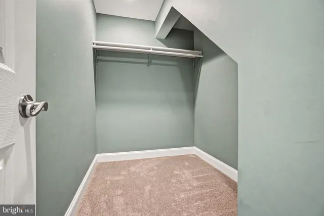 a view of an empty room with wooden walls