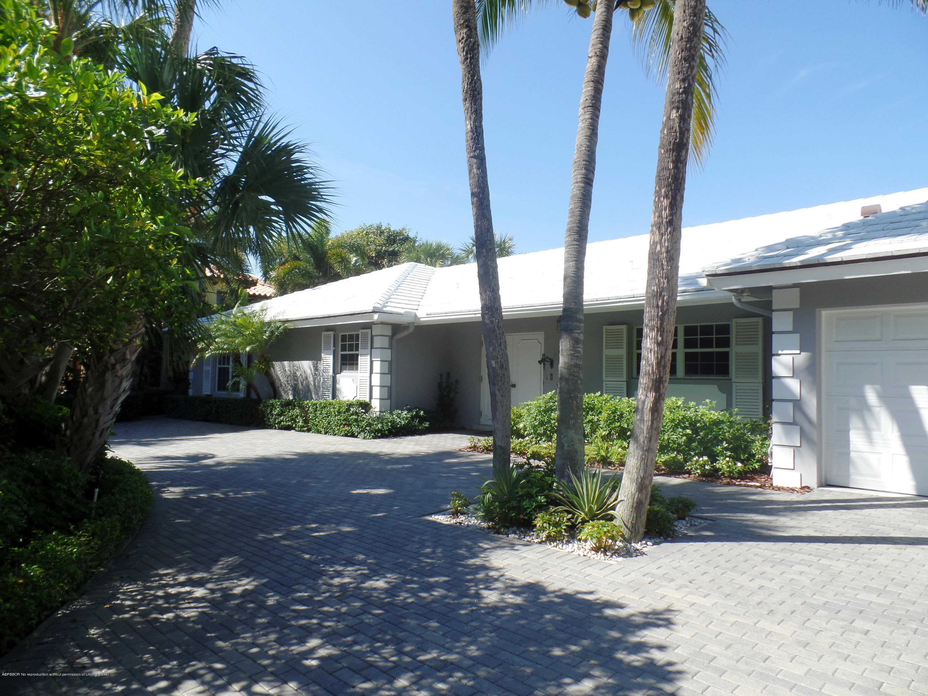 40 Middle Road Palm Beach, FL 33480 - Photo 1 of 2 a front view of a house with a yard and potted plants