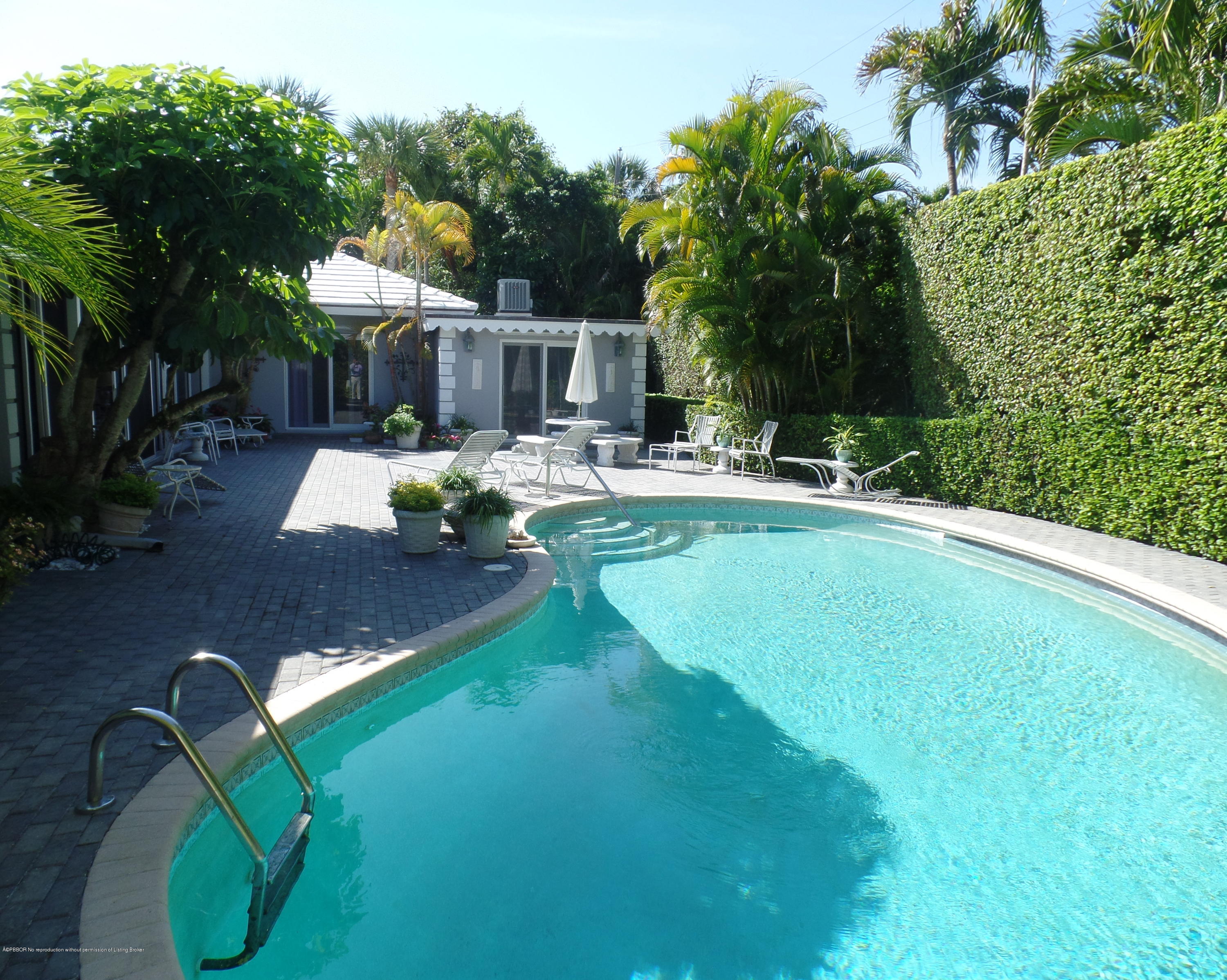40 Middle Road Palm Beach, FL 33480 - Photo 2 of 2 a view of a swimming pool with a patio