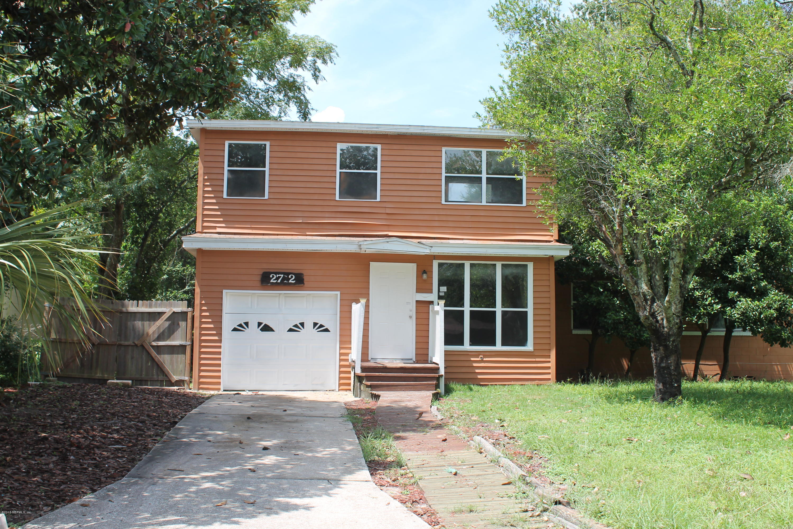 2712 Lorna Road Jacksonville, FL 32211 - Photo 1 of 30 a front view of a house with a garden and trees