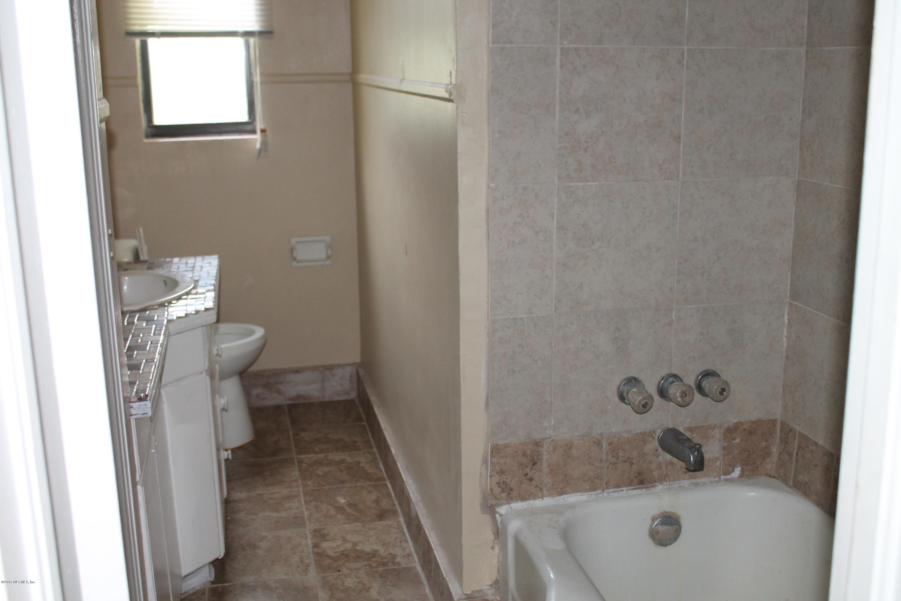 2712 Lorna Road Jacksonville, FL 32211 - Photo 12 of 30 a bathroom with a sink a toilet and shower
