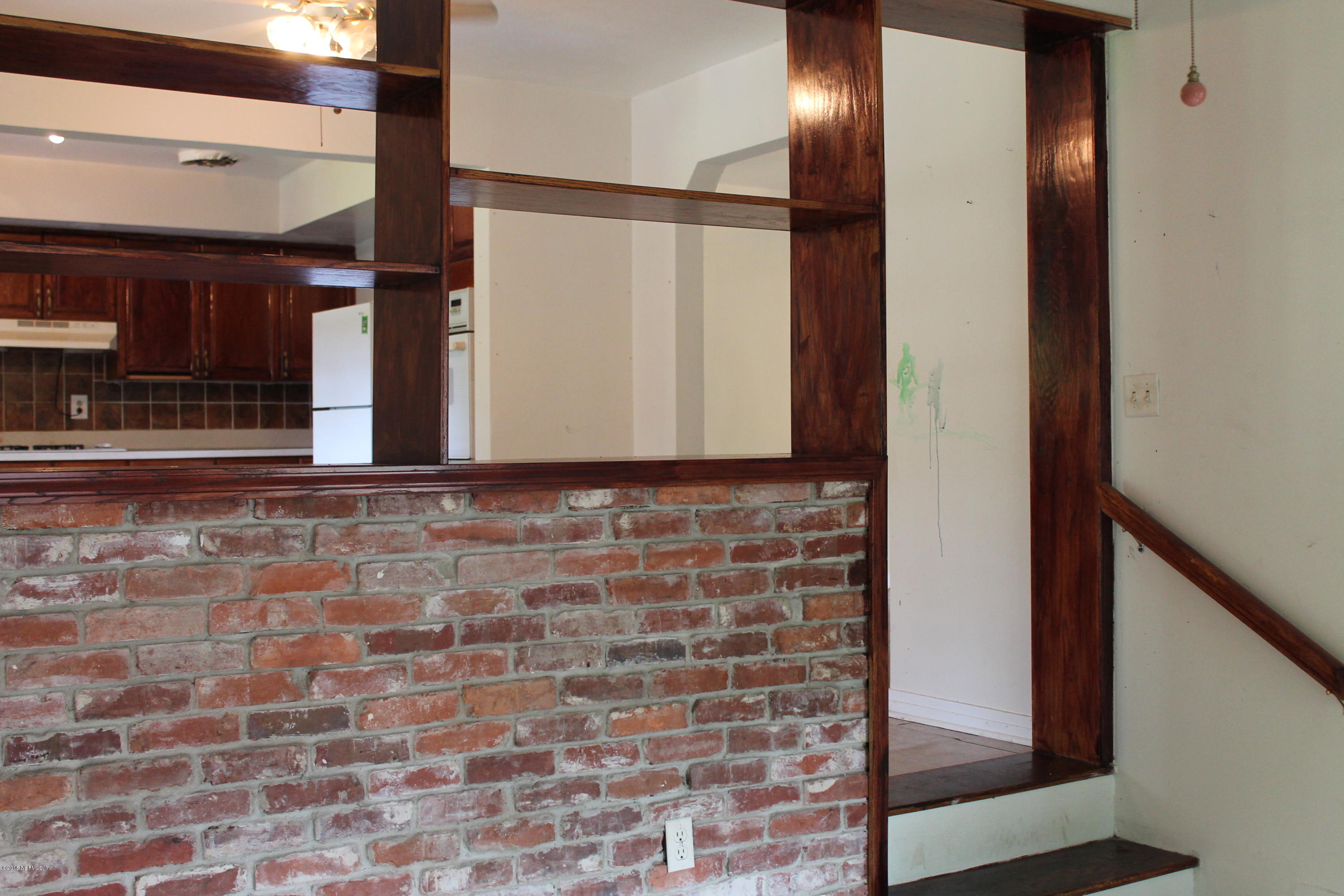 2712 Lorna Road Jacksonville, FL 32211 - Photo 10 of 30 a view of a hallway with brick walls