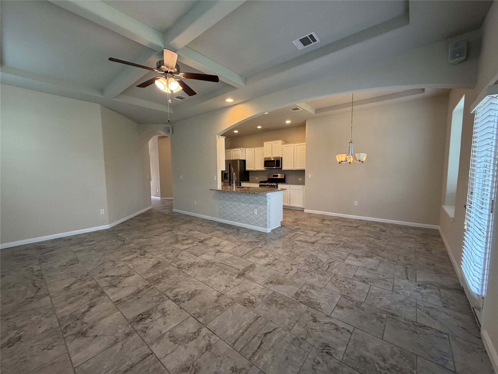 419 Gettysburg Loop Elgin, TX 78621 - Photo 21 of 21 An open floorplan seamlessly connects the well-lit kitchen and spacious living area.