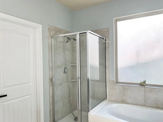 a bathroom with a bathtub and a shower