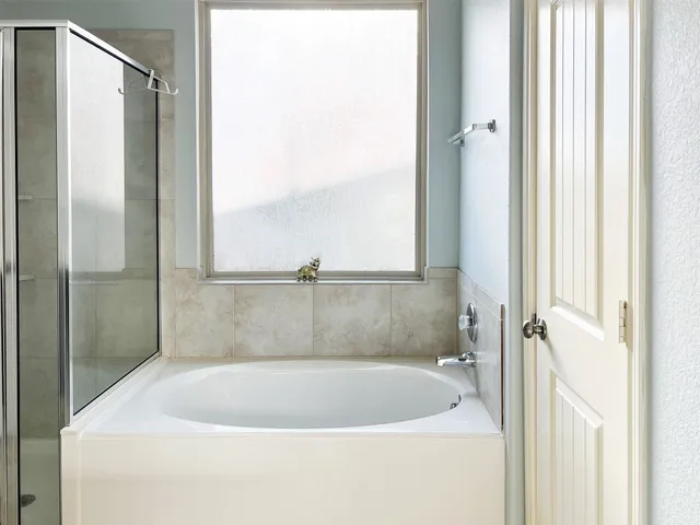 a white bath tub sitting next to a window