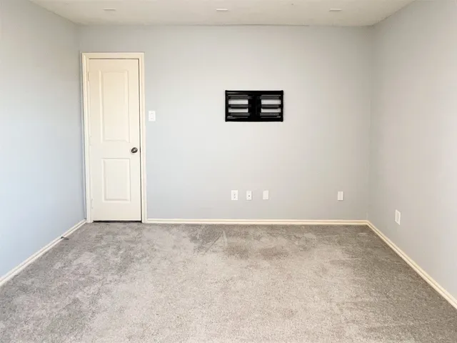 a view of a big room with windows and closet
