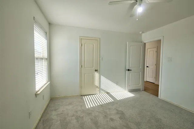 a view of a house with a wooden fence