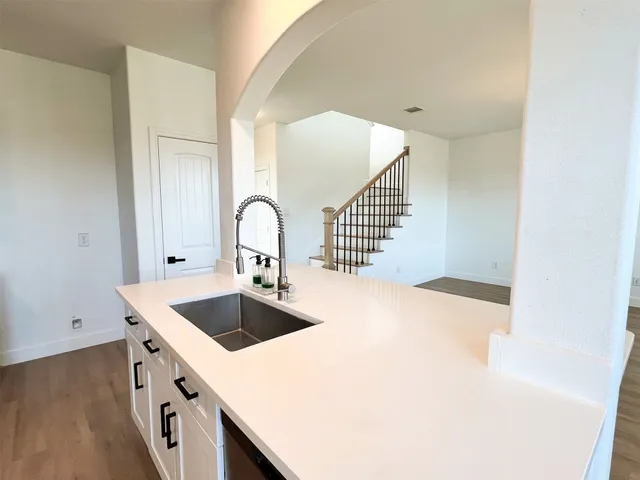 a kitchen with a sink and cabinets