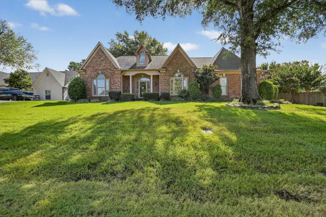 a front view of a house with yard