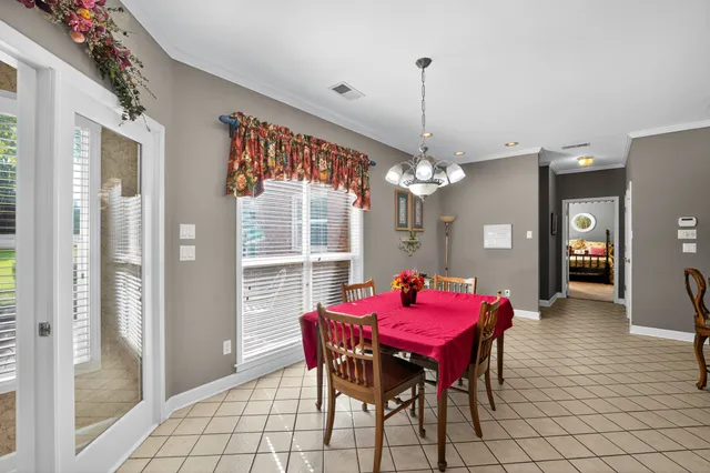 a view of a dining room with furniture and chandelier