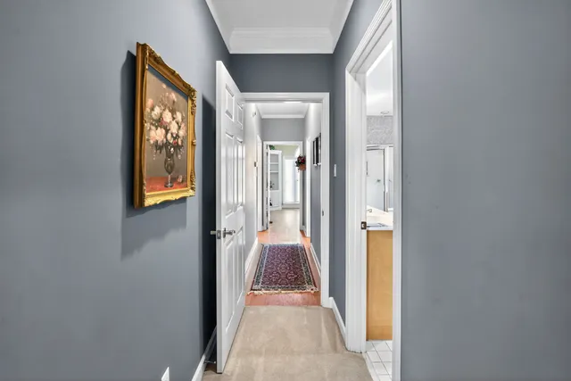 a view of a hallway with wooden floor and glass door