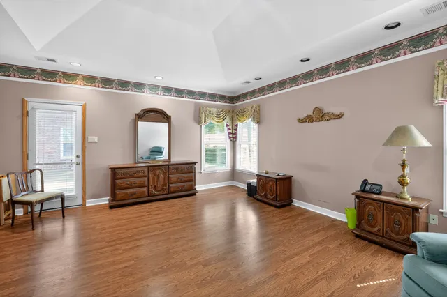 a living room with furniture and wooden floor