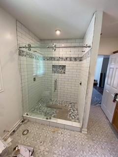 2924 Windsor Avenue Waco, TX 76708 - Photo 18 of 25 Glass-enclosed shower with subway tile walls, a mosaic tile accent band, and a built-in shower niche